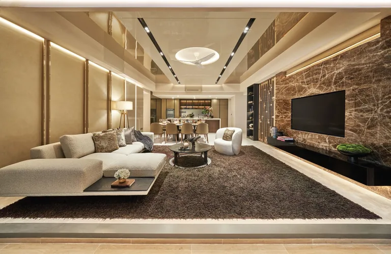 Newport Residences, interior photograph for illustration only: a living room with a low sofa, a marble feature wall and a dining area beyond