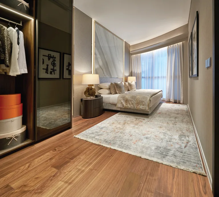 Newport Residences, interior photograph for illustration only: a bedroom with an engineered timber floor, an open wardrobe and soft curtains