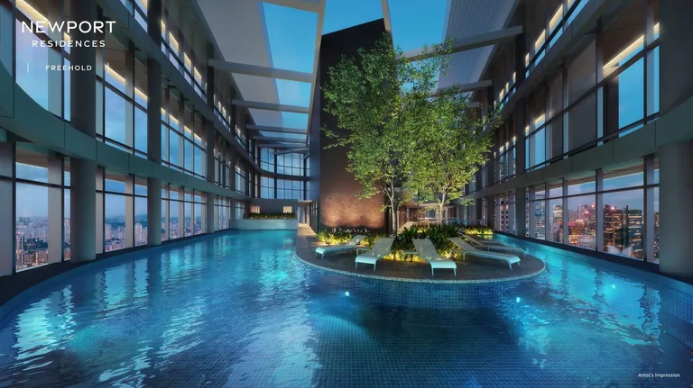 Newport Residences, artist’s impression: the Sky Pool on the roof garden, a curving pool around a planted island under a triple-height glazed roofscape at dusk
